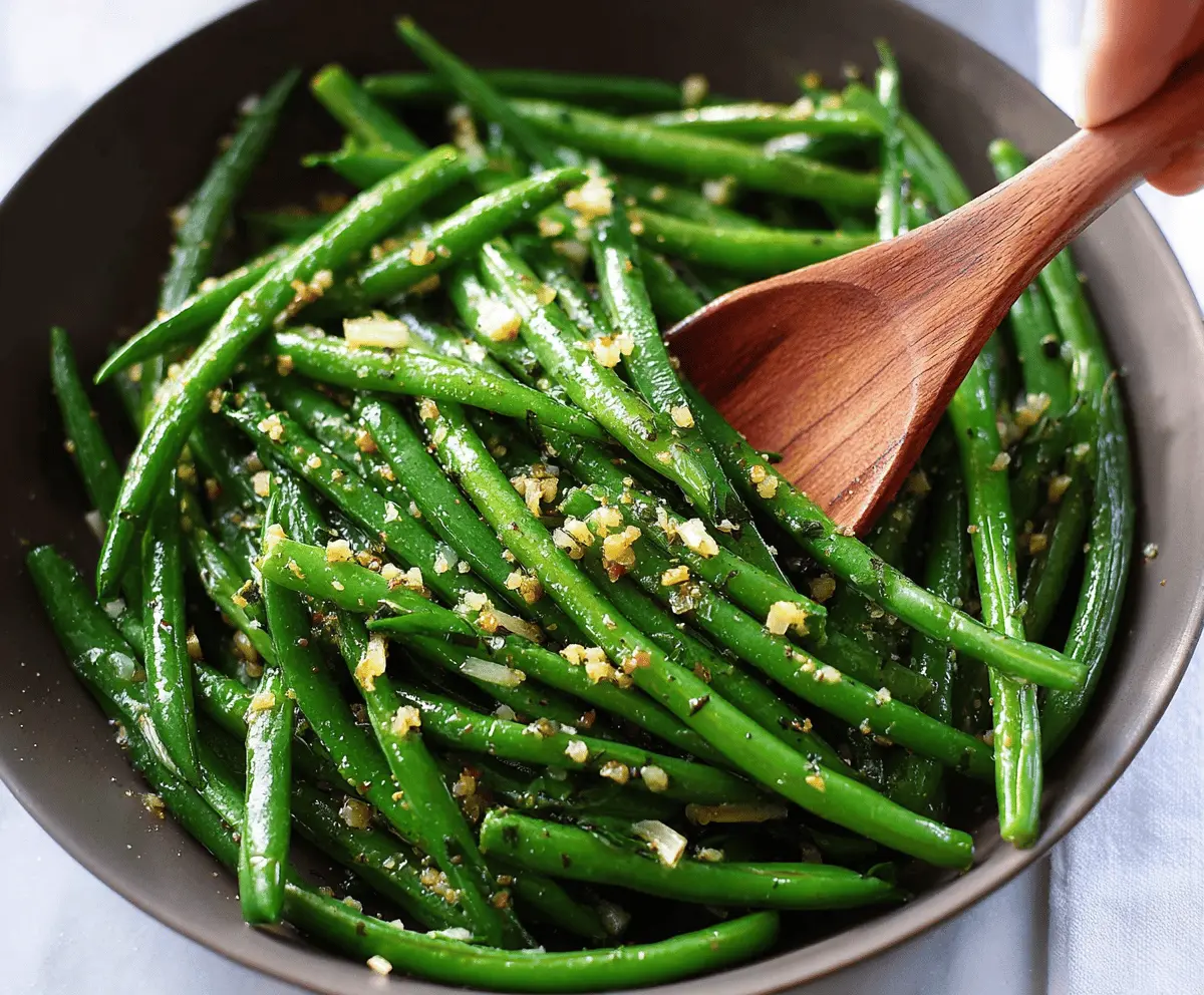 Fresh green beans cooked with garlic and butter, garnished for a delicious garlic butter green beans side dish.