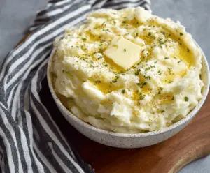 Creamy and fluffy Instant Pot mashed potatoes topped with fresh herbs, perfect for a delicious side dish