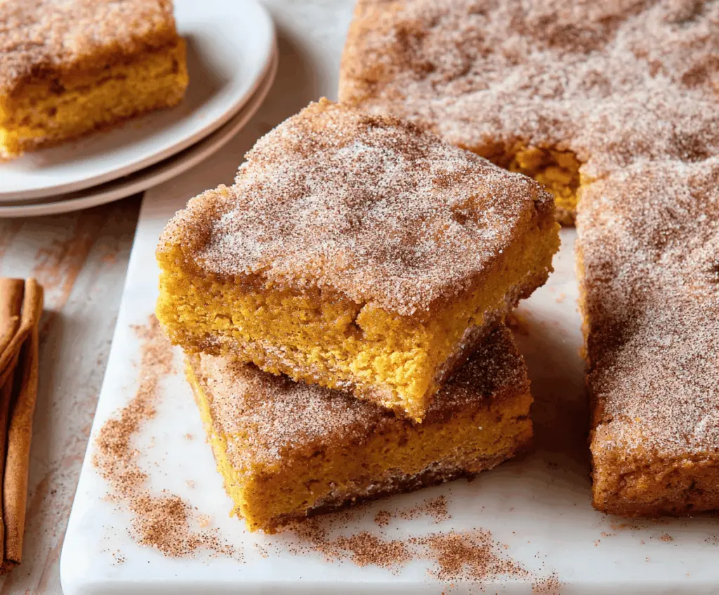 Delicious Pumpkin Snickerdoodle Bars topped with cinnamon sugar, ready to enjoy as a seasonal fall dessert.