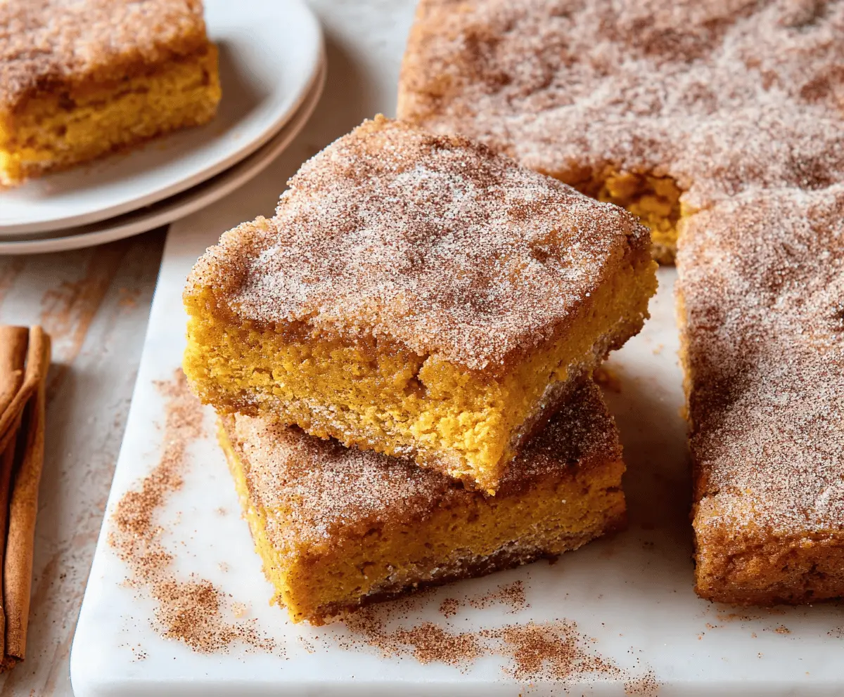 Delicious Pumpkin Snickerdoodle Bars topped with cinnamon sugar, ready to enjoy as a seasonal fall dessert.
