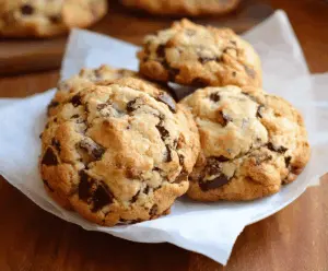 Delicious Levain Bakery chocolate chip cookies fresh out of the oven, showcasing gooey chocolate chunks and golden-brown crust.