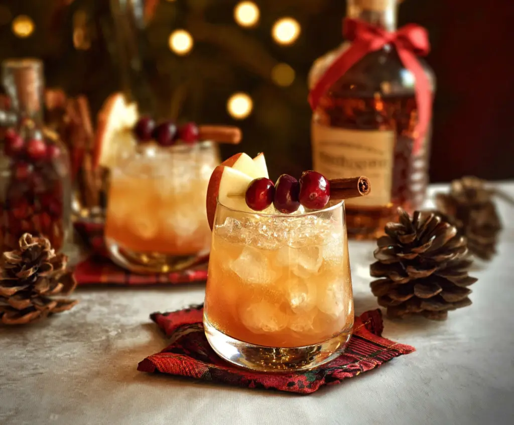 Festive Christmas Bourbon Cocktails with cinnamon and garnishes for holiday celebration.