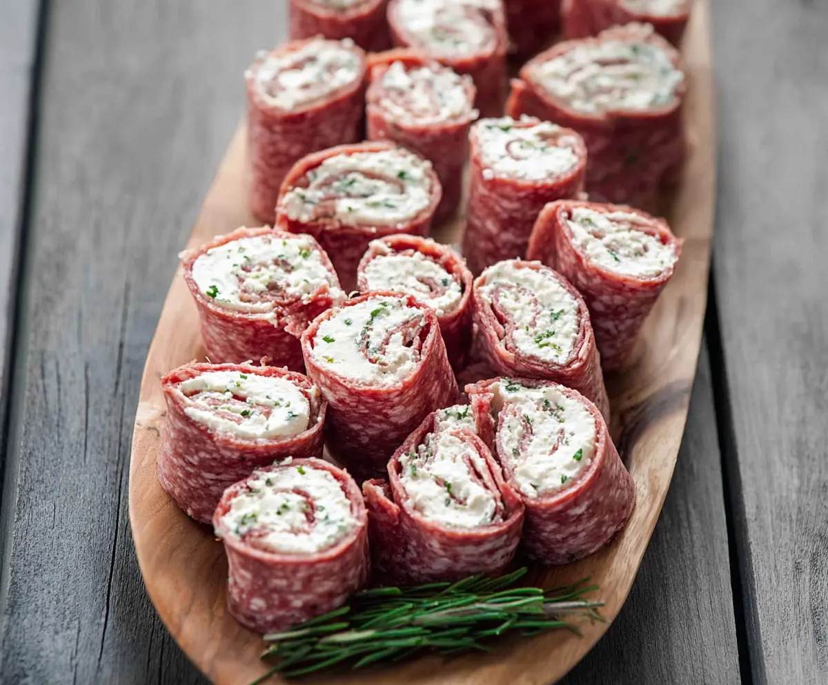 Delicious salami and cream cheese roll-ups with fresh herbs for a tasty appetizer.