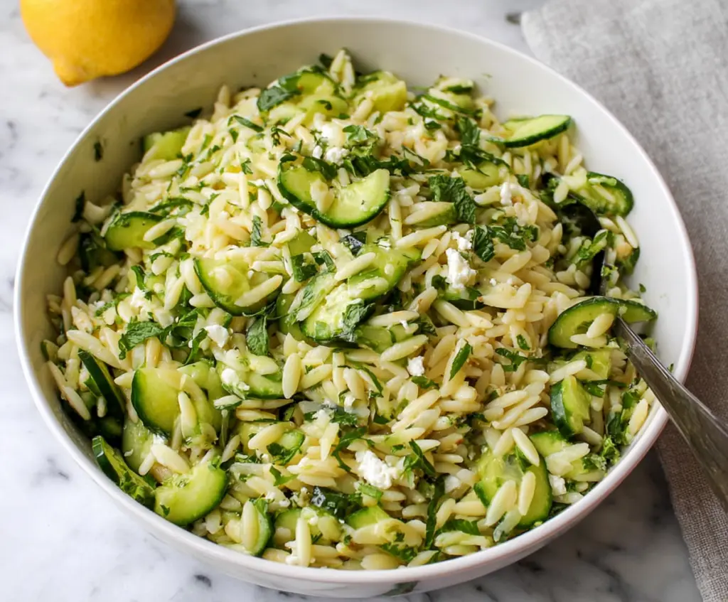 Fresh cucumber and lemon orzo salad in a bowl, perfect for summer meals