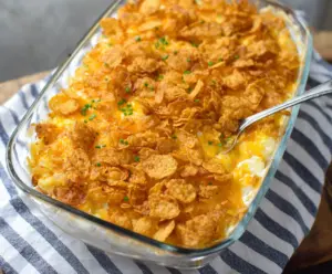 Delicious cheesy potatoes topped with crispy corn flakes, perfect for a comforting meal.