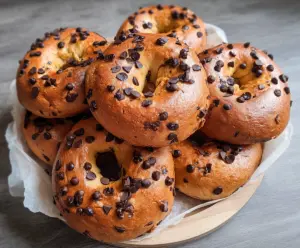 Freshly baked chocolate chip bagels with melted chocolate chips and a crispy golden crust.