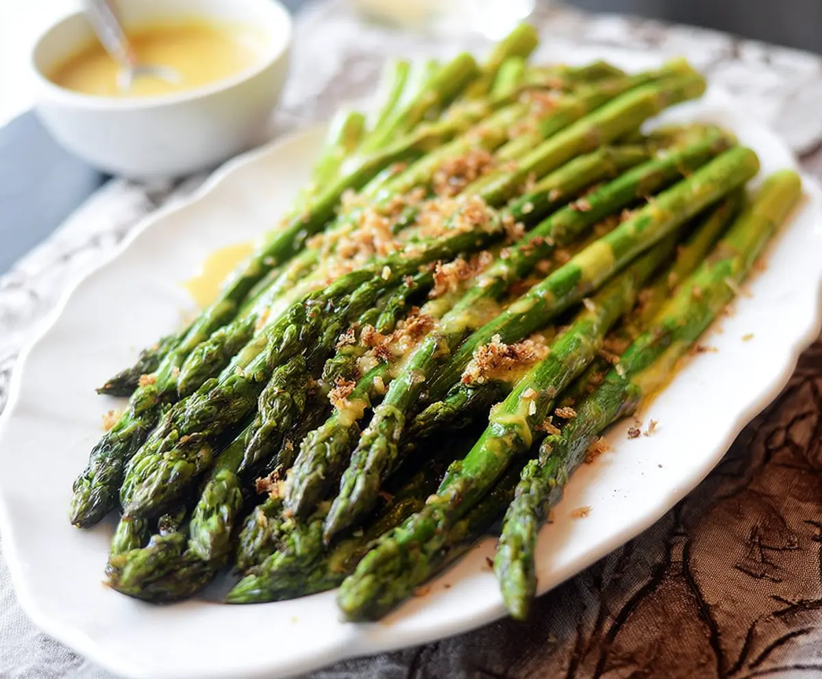 Delicious honey mustard glazed asparagus spears on a white plate, perfect for healthy side dishes.