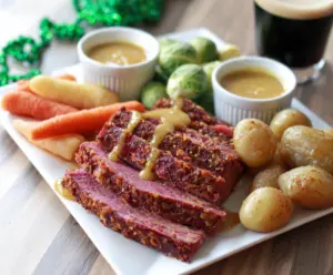 Delicious Instant Pot corned beef with mustard glaze served on a plate.